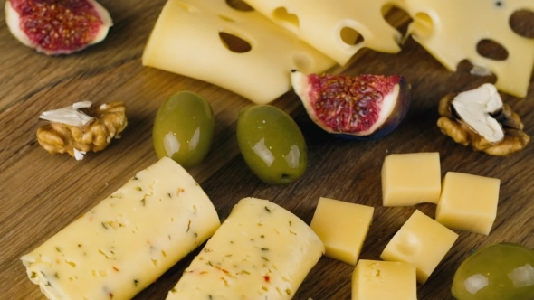 A Set Of Different Cheeses With Figs, Turns To The