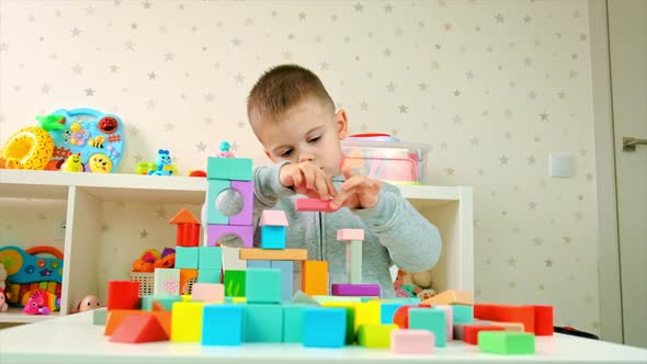 The Child Plays with Toys in the Room