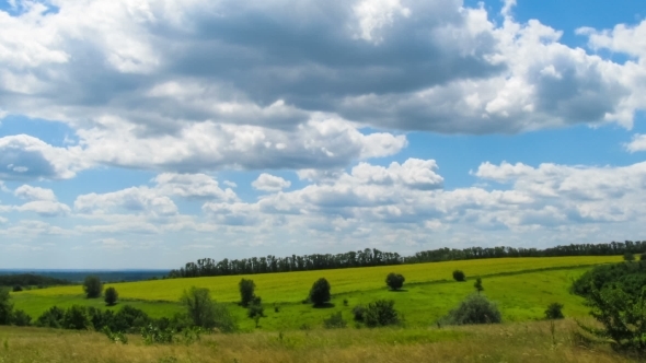Landscape, Clouds Moving Over a Field With Trees.