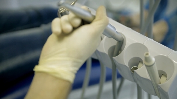 A Dentist Drills a Tooth