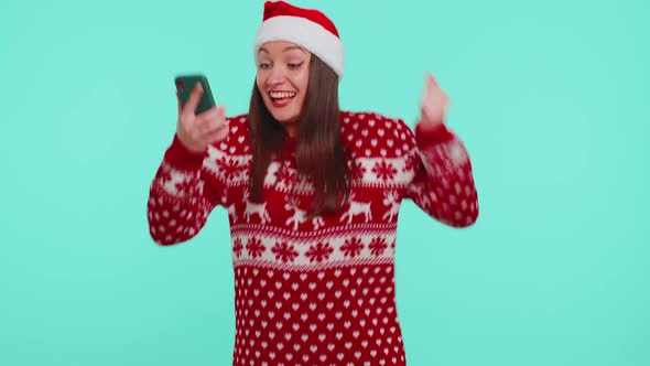 Adult Girl in Red Christmas Sweater Looking Smartphone Display Sincerely Rejoicing Win Success Luck