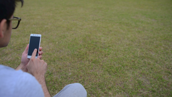 Smartphone, Man Using while Sitting on Grass