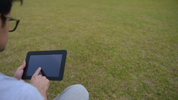 Digital Tab, Man Using while Sitting on Grass