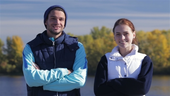 Male And Female Joggers Smiling At The Camera
