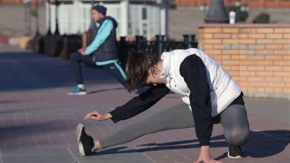 Couple Stretching Before Workout In The City