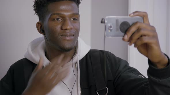 Happy Guy Having Video Call in Headphones with Mobile Phone