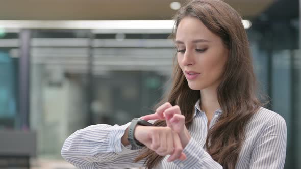 Portrait of Young Businesswoman using Smartwatch