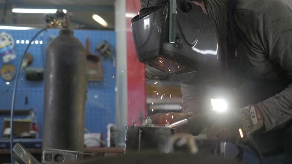 Welding Process. Welder In Helmet Works, Worker Works In The Auto Workshop