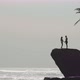 Romantic Couple Standing on Rocks by Sea - VideoHive Item for Sale