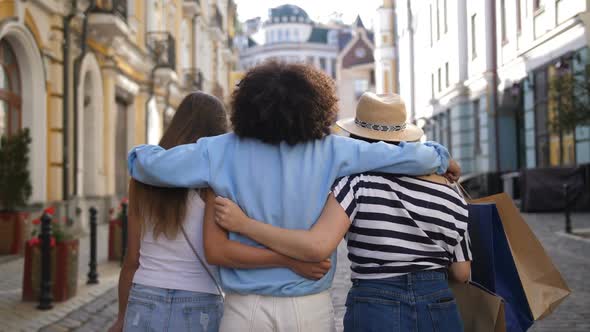 Multiracial Girls Embracing While Shopping