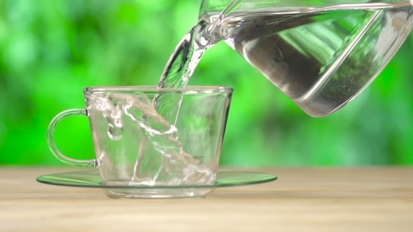 Hot Steaming Water Pouring In To The Cup