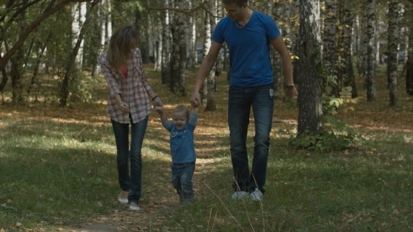 Happy Young Family Is Having Fun In The Autumn