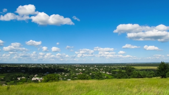 Clouds Moving Over a Field With Trees.