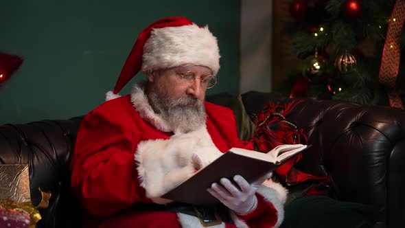 Santa Claus Is Reading a Book with Fairy Tales