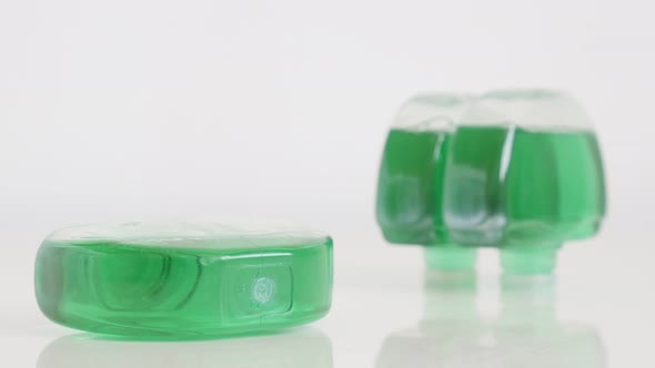 Plastic toilet bowl deodorizers on white 4K tilting video alt