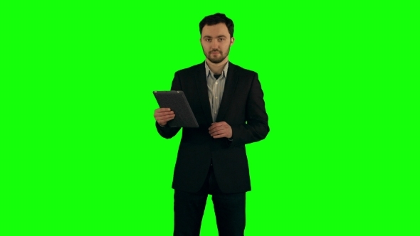 Businessman Using His Tablet On a Green Screen