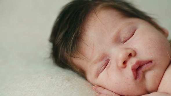 Cute Newborn Baby Sleeping On a Blanket