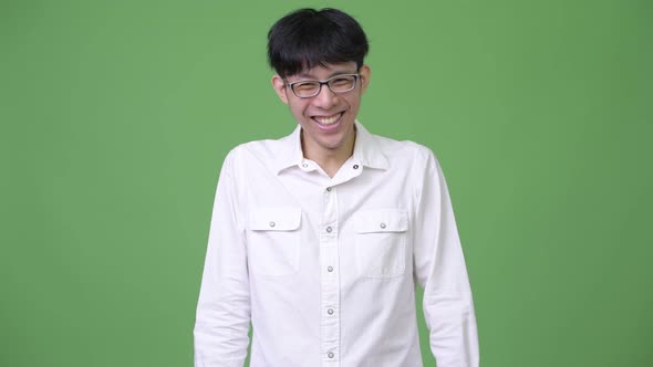 Happy Young Asian Businessman Laughing