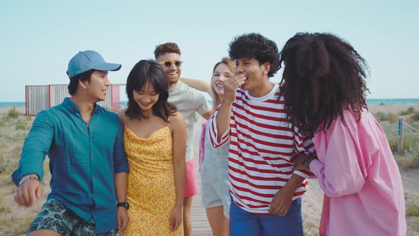 Group of friends having fun on the beach.