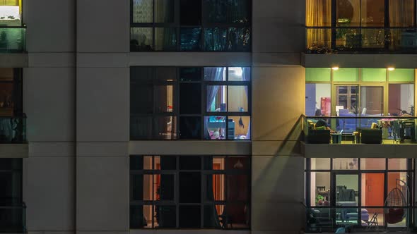 Windows of Apartment Building at Night Timelapse the Light From Illuminated Rooms of Houses