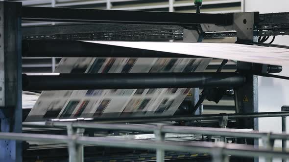 Closeup Shot of Newspaper Production on a Conveyor Belt