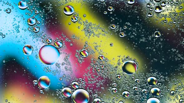 Abstract Colorful Food Oil Drops Bubbles and spheres Flowing on Water Surface