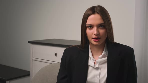 Businesswoman Speaking Looking at Camera Talking Make Video Conference on Couch at Home Office