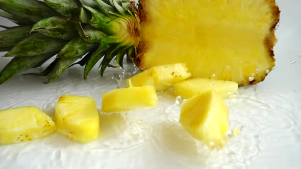 Falling juicy pieces of pineapple. Slow motion.