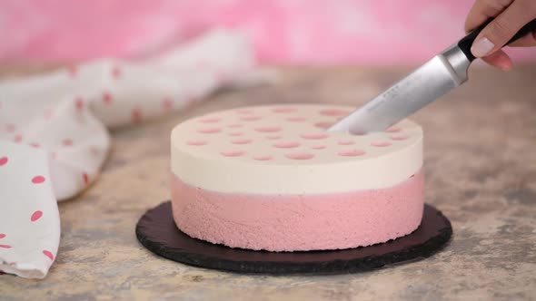 Cutting delicious strawberry mousse cake. Sweet food
