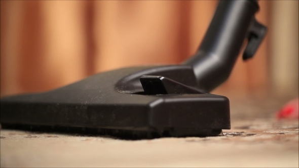 Women Presses a Button On The Vacuum Cleaner