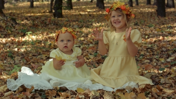 Little Baby And Girl In The Autumn Park
