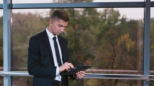 Young Businessman Working With The Tablet