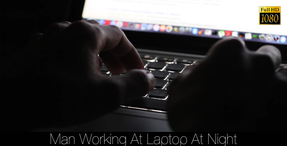 Man Working At Laptop At Night