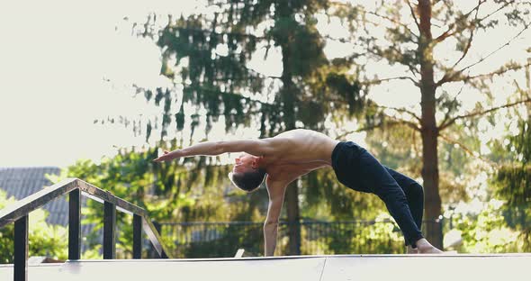 Man Practicing a Single Hand Balance Pose Focusing on Backbend