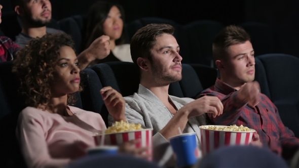 A Group Of People Watching a Movie Showing Emotion