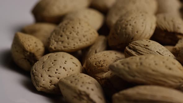 Cinematic, rotating shot of almonds on a white surface - ALMONDS 