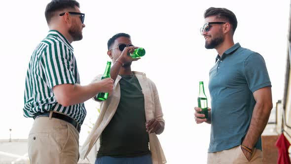 Happy Male Friends Drinking Beer at Rooftop Party