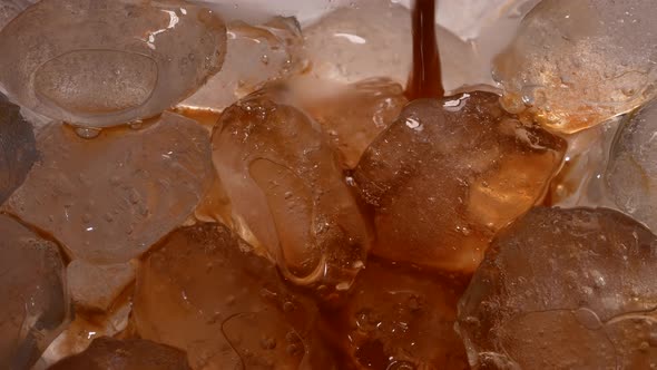 Black Coffee is Poured Into a Glass Filled with Ice Cubes to Create a Refreshing Coffee Drink