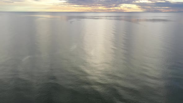 AERIAL: Reveal Shot of Majestic Cloudy Sky Above Baltic Sea on a Evening 