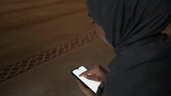 Young Woman Reading Quran Smarthphone