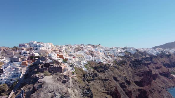 Drone view over Santorini, aerial view over the whitewashed village of Oia with luxury vacation reso
