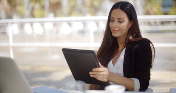 Pretty Businesswoman Working On a Tablet