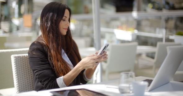 Businesswoman Checking Her Mobile Phone