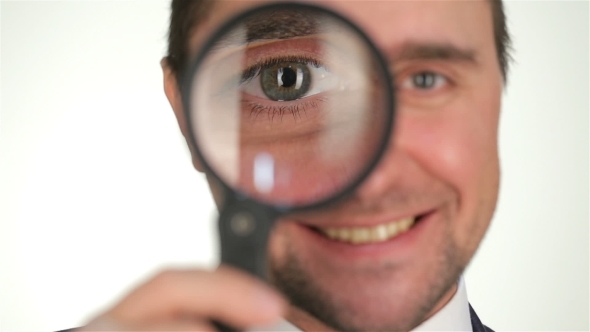 Businessman Looking Through Magnifying Glass