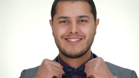 The Well-dressed Male Straightens Bow Tie