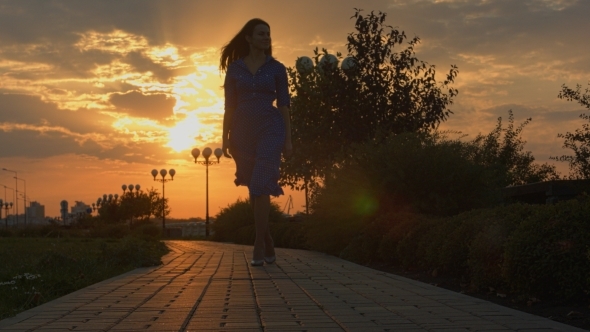 Girl Walks Away And Turnes Back At The Sunset.