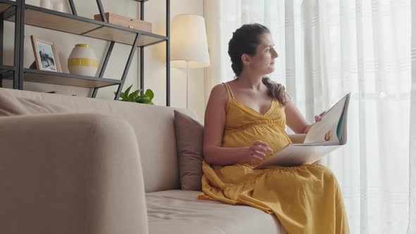 Pregnant Woman Resting at Home and Reading Book