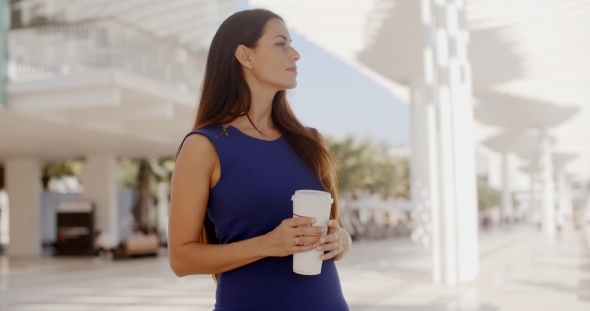 Attractive Woman Holding a Large Cup Of Coffee