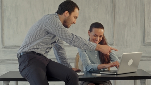 Serious Business Man And Woman With Laptop