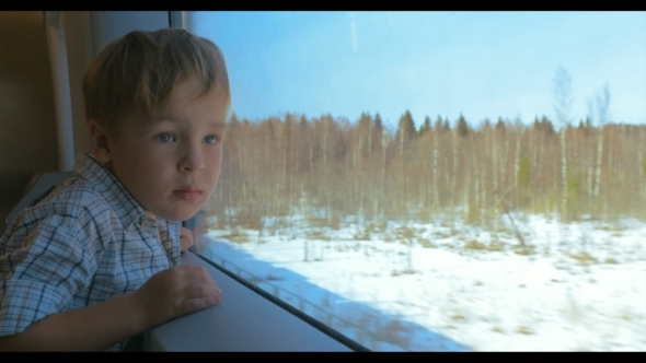 Boy Looking Out The Window Of Moving Train